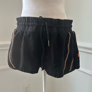 2XU Black Women's Running Shorts with Orange Accents and Small Zipper Pocket